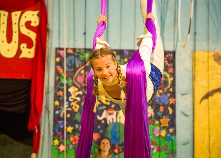 Circus camper performs on aerial silks