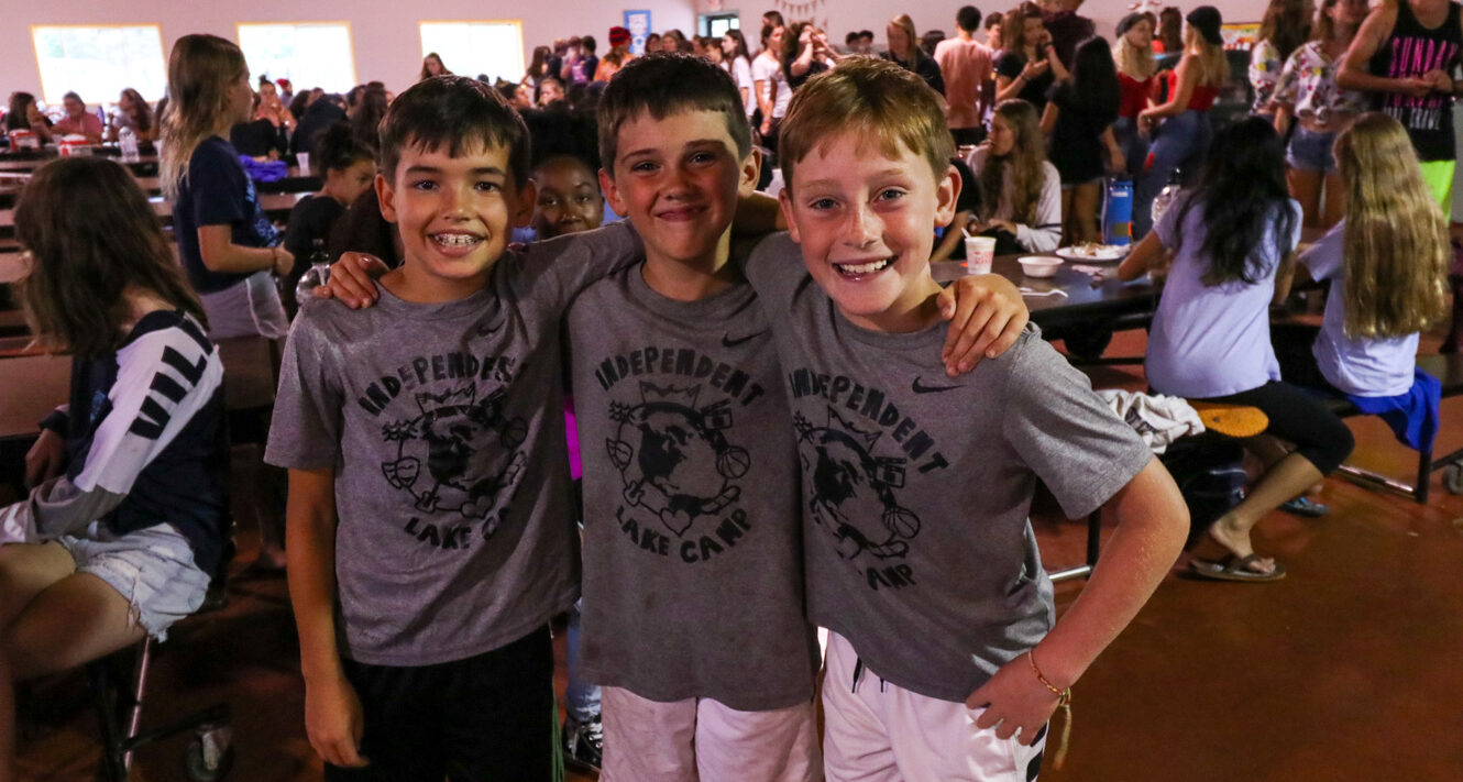 Campers stand together at mealtime