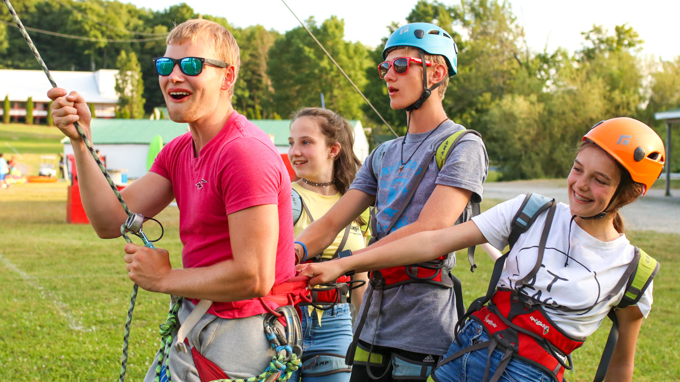 Campers pull on ropes to prep for course