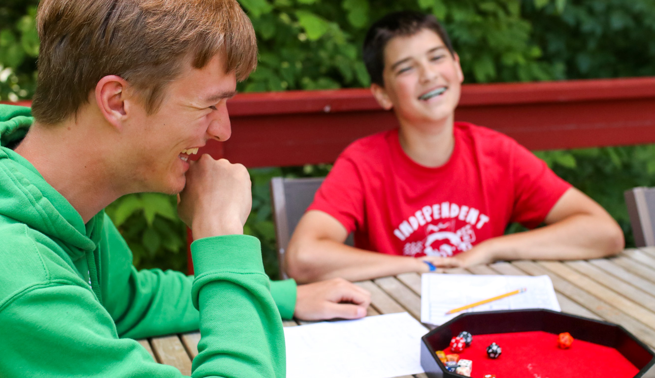 Boys play tabletop RPG at summer camp