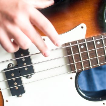 Close up of finger playing guitar