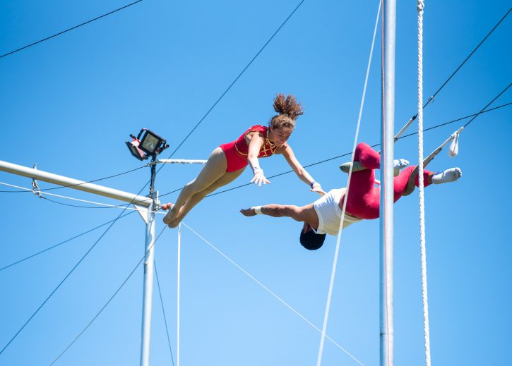 Two campers perform trapeze